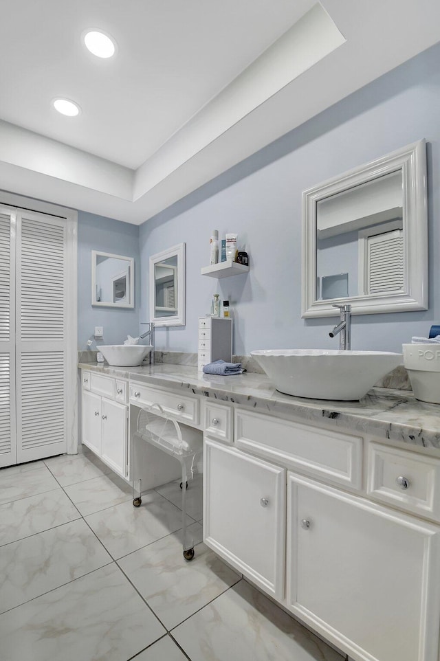 438 Pine Villa Dr, Atlantis, FL 33462 - full bath with double vanity, marble look tiles, recessed lighting, a tray ceiling, and a closet