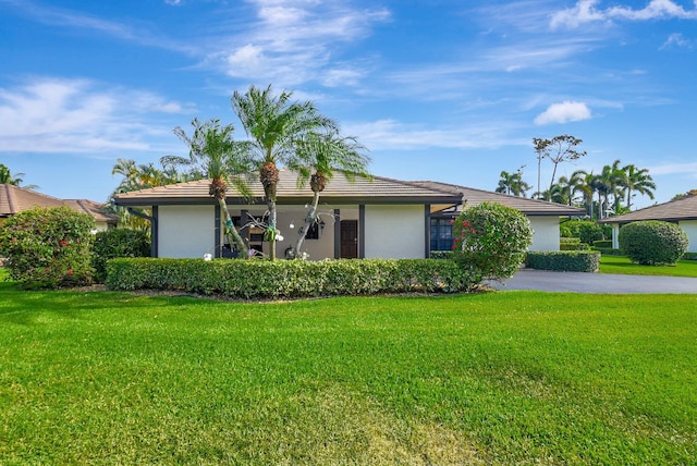 438 Pine Villa Dr, Atlantis, FL 33462 - ranch-style home with stucco siding and a front lawn