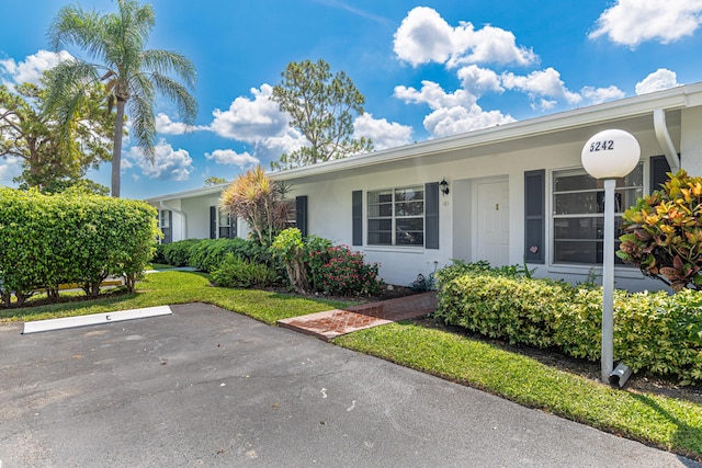 5242 Privet Pl Unit C, Delray Beach, FL 33484 - ranch-style house with stucco siding and uncovered parking