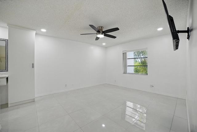 5242 Privet Pl Unit C, Delray Beach, FL 33484 - unfurnished room with ceiling fan, a textured ceiling, recessed lighting, light tile patterned flooring, and baseboards