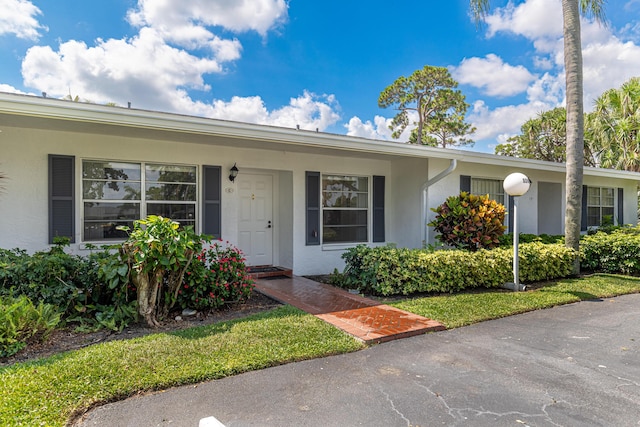 5242 Privet Pl Unit C, Delray Beach, FL 33484 - view of front of home featuring stucco siding and covered porch