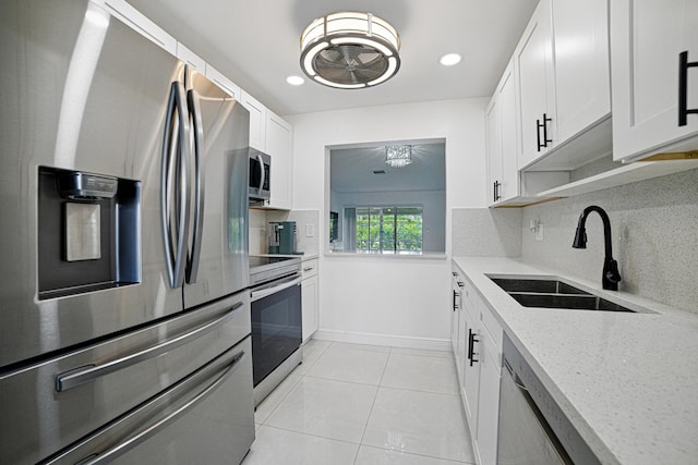 5242 Privet Pl Unit C, Delray Beach, FL 33484 - kitchen with stainless steel appliances, a sink, light tile patterned floors, decorative backsplash, and recessed lighting