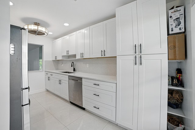 5242 Privet Pl Unit C, Delray Beach, FL 33484 - kitchen with appliances with stainless steel finishes, a sink, light countertops, light tile patterned floors, and white cabinets