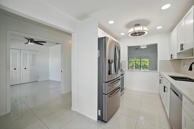 5242 Privet Pl Unit C, Delray Beach, FL 33484 - kitchen featuring stainless steel appliances, a sink, white cabinetry, a ceiling fan, and light tile patterned flooring