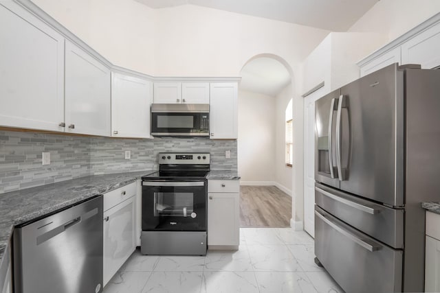 5761 Spanish River Rd, Fort Pierce, FL 34951 - kitchen featuring stainless steel appliances, light marble finish flooring, white cabinets, and stone counters