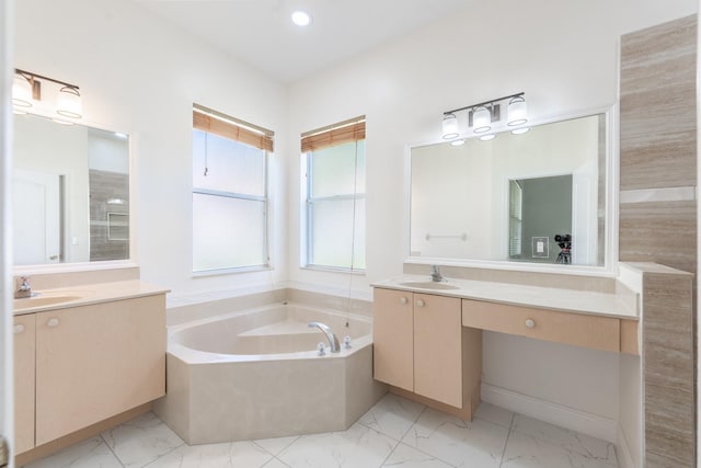 5761 Spanish River Rd, Fort Pierce, FL 34951 - bathroom with marble finish floors, a bath, two vanities, and recessed lighting