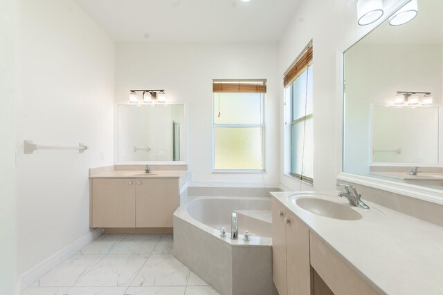 5761 Spanish River Rd, Fort Pierce, FL 34951 - full bathroom featuring marble look tile flooring, a garden tub, and two vanities