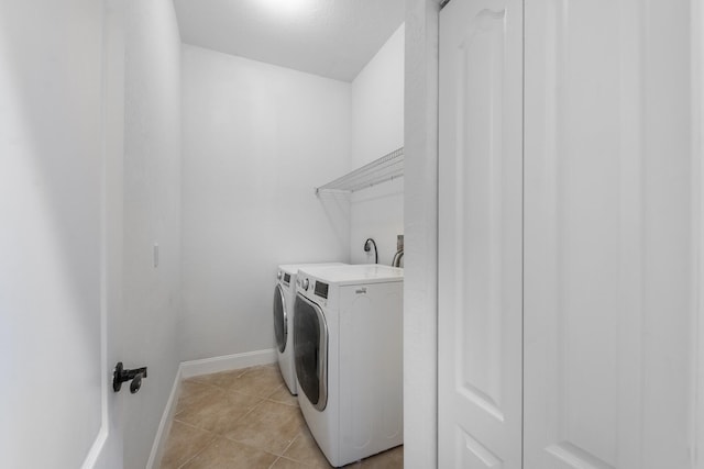5761 Spanish River Rd, Fort Pierce, FL 34951 - washroom with washing machine and dryer, light tile patterned flooring, and baseboards