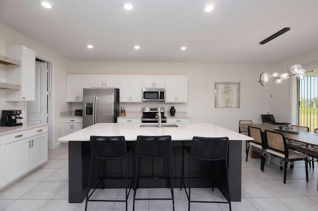 7499 NW Deysbrook Ln, Port Saint Lucie, FL 34987 - kitchen featuring stainless steel appliances, a sink, light countertops, white cabinets, and recessed lighting