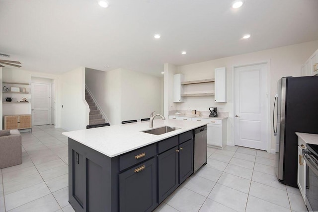 7499 NW Deysbrook Ln, Port Saint Lucie, FL 34987 - kitchen featuring a sink, white cabinetry, open shelves, open floor plan, and stainless steel appliances