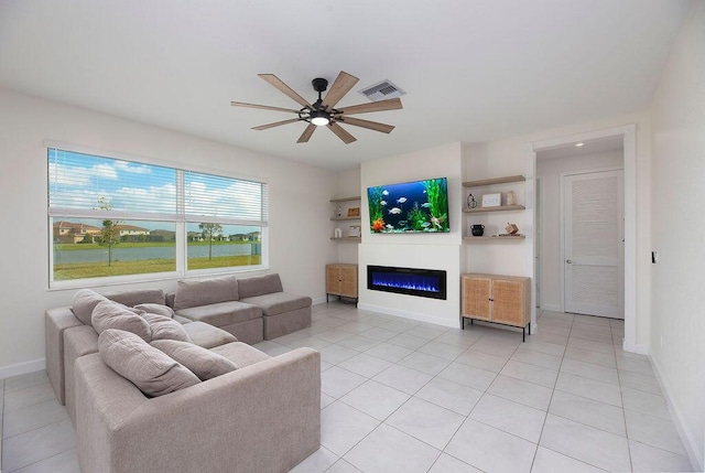 7499 NW Deysbrook Ln, Port Saint Lucie, FL 34987 - living room with a ceiling fan, a glass covered fireplace, light tile patterned floors, and baseboards