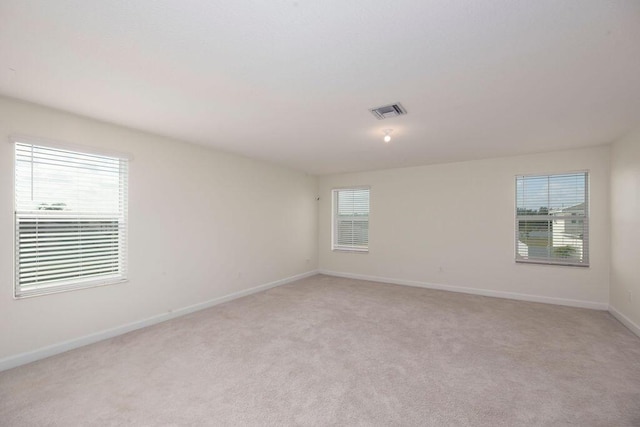 7499 NW Deysbrook Ln, Port Saint Lucie, FL 34987 - empty room featuring light colored carpet and baseboards
