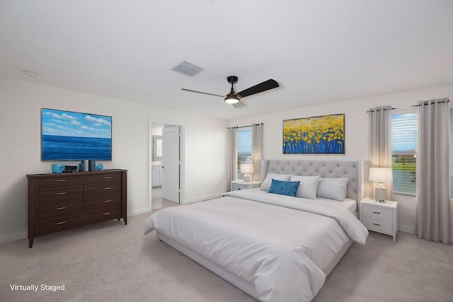 7499 NW Deysbrook Ln, Port Saint Lucie, FL 34987 - bedroom featuring multiple windows, light carpet, and baseboards