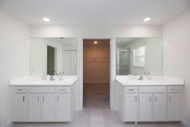 7499 NW Deysbrook Ln, Port Saint Lucie, FL 34987 - full bath featuring a shower stall, two vanities, a walk in closet, baseboards, and recessed lighting