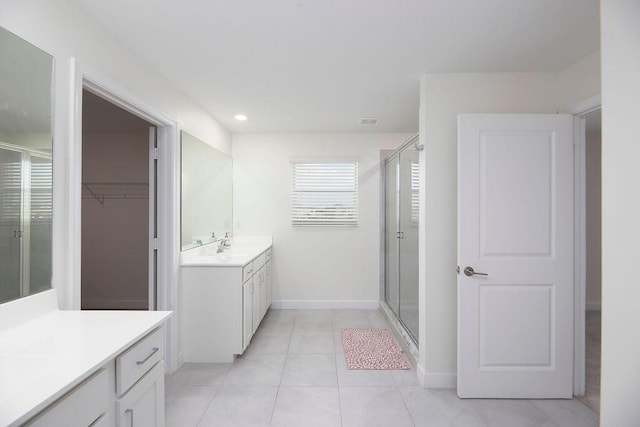 7499 NW Deysbrook Ln, Port Saint Lucie, FL 34987 - bathroom featuring a shower stall, two vanities, tile patterned floors, recessed lighting, and baseboards