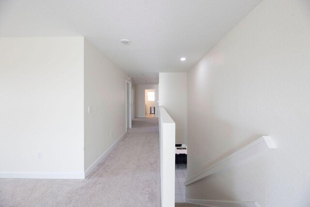 7499 NW Deysbrook Ln, Port Saint Lucie, FL 34987 - corridor with light colored carpet, baseboards, and recessed lighting
