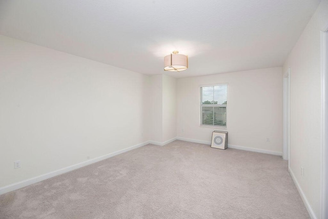 7499 NW Deysbrook Ln, Port Saint Lucie, FL 34987 - empty room featuring light carpet and baseboards