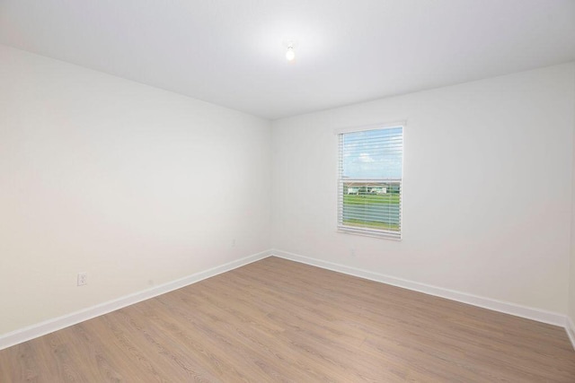 7499 NW Deysbrook Ln, Port Saint Lucie, FL 34987 - spare room with baseboards and wood finished floors
