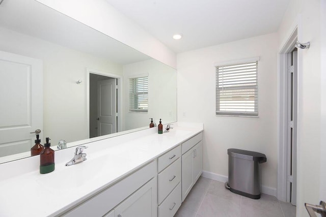7499 NW Deysbrook Ln, Port Saint Lucie, FL 34987 - full bath featuring double vanity, baseboards, tile patterned flooring, and recessed lighting