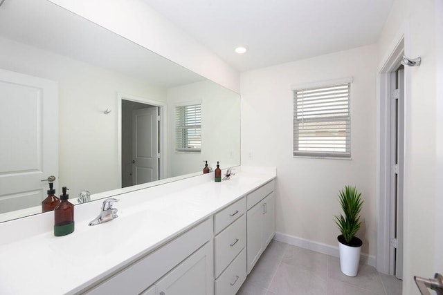 7499 NW Deysbrook Ln, Port Saint Lucie, FL 34987 - bathroom with double vanity, baseboards, tile patterned floors, and recessed lighting