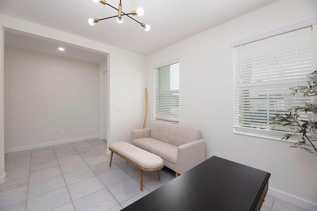 7499 NW Deysbrook Ln, Port Saint Lucie, FL 34987 - living area with a chandelier, light tile patterned floors, and baseboards