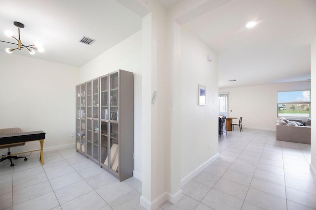 7499 NW Deysbrook Ln, Port Saint Lucie, FL 34987 - corridor featuring tile patterned floors, a chandelier, and baseboards