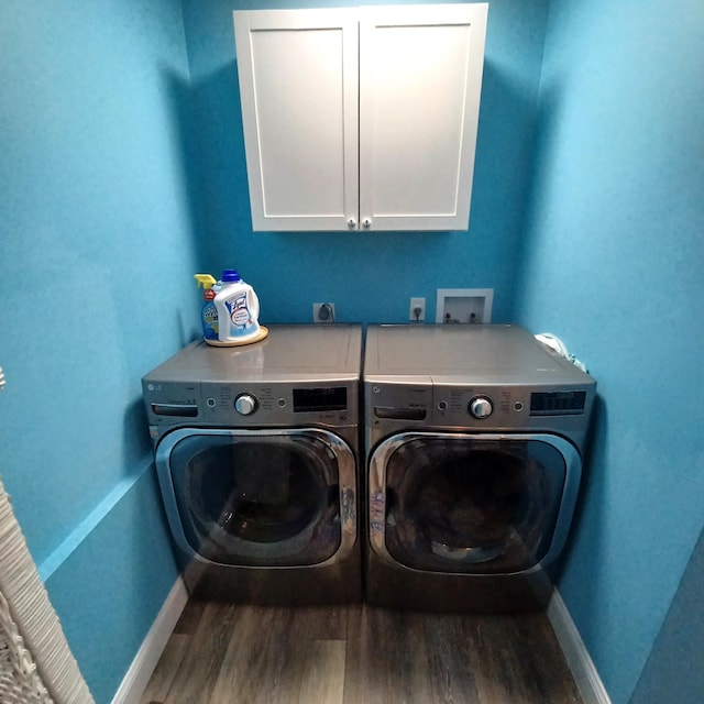 54 Piedmont Unit B, Delray Beach, FL 33484 - washroom with washing machine and dryer, cabinet space, wood finished floors, and baseboards