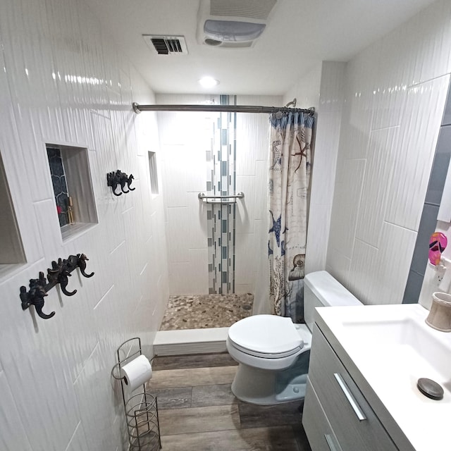 54 Piedmont Unit B, Delray Beach, FL 33484 - full bathroom featuring toilet, a tile shower, wood finished floors, and vanity