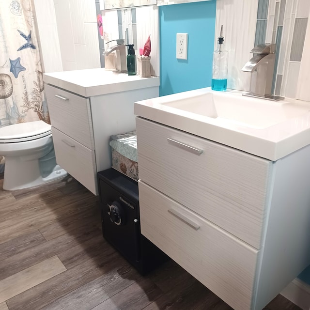 54 Piedmont Unit B, Delray Beach, FL 33484 - bathroom with vanity, wood finished floors, and toilet