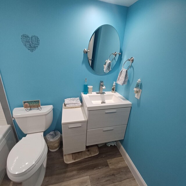 54 Piedmont Unit B, Delray Beach, FL 33484 - full bath featuring vanity, wood finished floors, toilet, and a tub to relax in