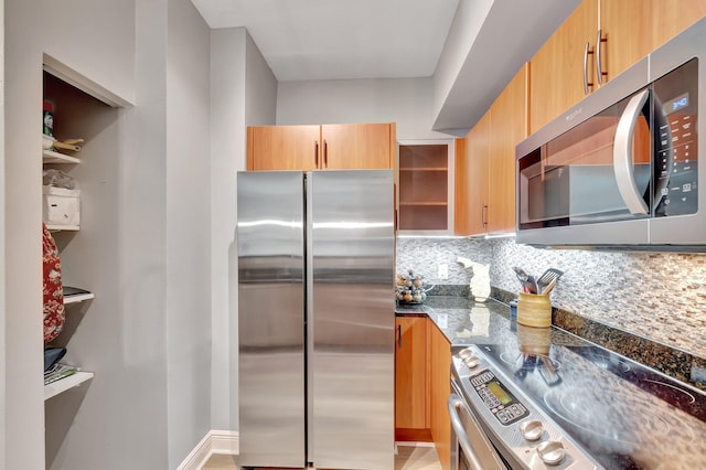 804 E Windward Way Unit 404, Lantana, FL 33462 - kitchen with appliances with stainless steel finishes, open shelves, dark stone countertops, tasteful backsplash, and light brown cabinetry