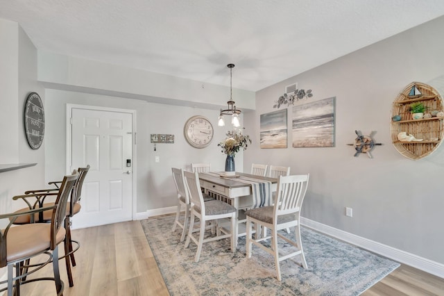 804 E Windward Way Unit 404, Lantana, FL 33462 - dining space featuring light wood finished floors, baseboards, and a chandelier