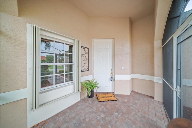 415 NW Granville St, Port Saint Lucie, FL 34986 - view of exterior entry with stucco siding and covered porch