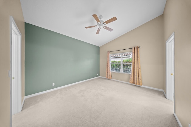 415 NW Granville St, Port Saint Lucie, FL 34986 - spare room featuring vaulted ceiling, baseboards, carpet floors, and ceiling fan