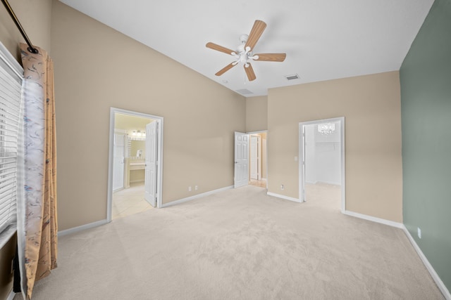 415 NW Granville St, Port Saint Lucie, FL 34986 - unfurnished bedroom featuring carpet flooring, a walk in closet, baseboards, ceiling fan, and connected bathroom