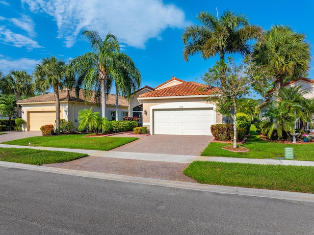 415 NW Granville St, Port Saint Lucie, FL 34986 - mediterranean / spanish house with stucco siding, a tile roof, a front lawn, and a garage