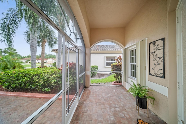 415 NW Granville St, Port Saint Lucie, FL 34986 - unfurnished sunroom with brick floors and a textured wall