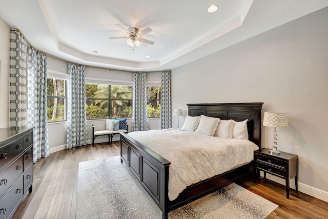 8271 Canopy Ter, Parkland, FL 33076 - bedroom with a tray ceiling, baseboards, light wood-style flooring, recessed lighting, and a ceiling fan