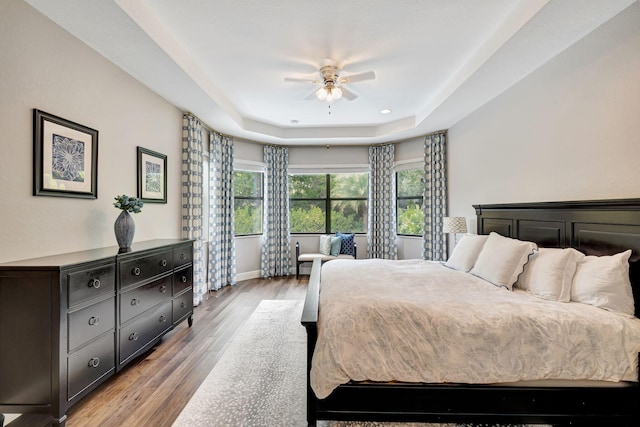 8271 Canopy Ter, Parkland, FL 33076 - bedroom featuring a raised ceiling, light wood-style flooring, baseboards, and a ceiling fan
