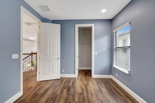 8271 Canopy Ter, Parkland, FL 33076 - unfurnished bedroom featuring baseboards, dark wood-style floors, a spacious closet, and a closet