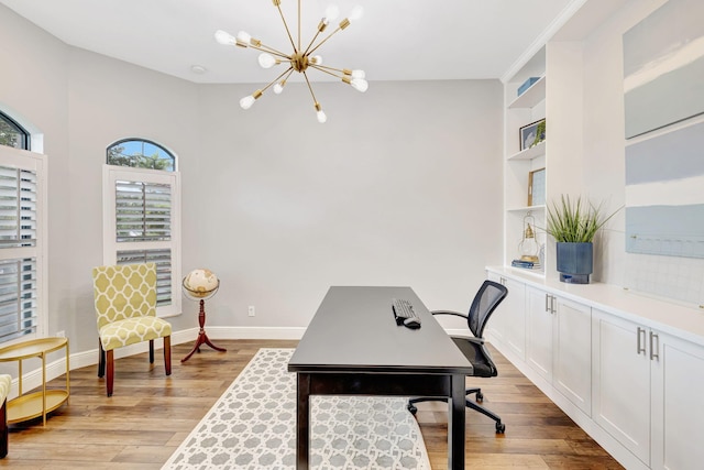 8271 Canopy Ter, Parkland, FL 33076 - home office with a chandelier, light wood finished floors, built in shelves, and baseboards