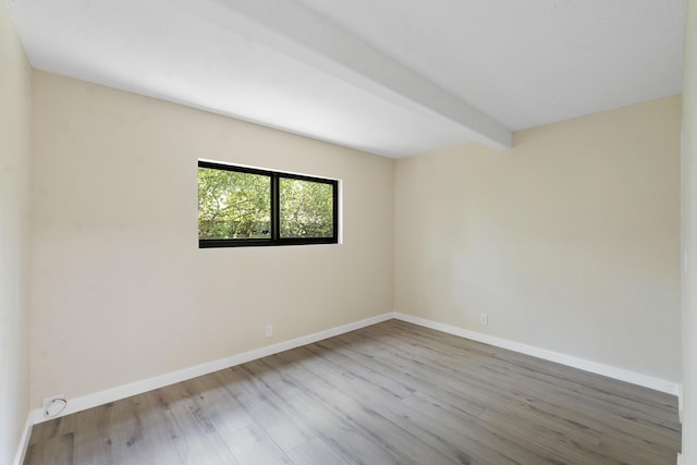 1325 S Flagler Ave Unit 104, Pompano Beach, FL 33060 - unfurnished room featuring wood finished floors, baseboards, and beam ceiling