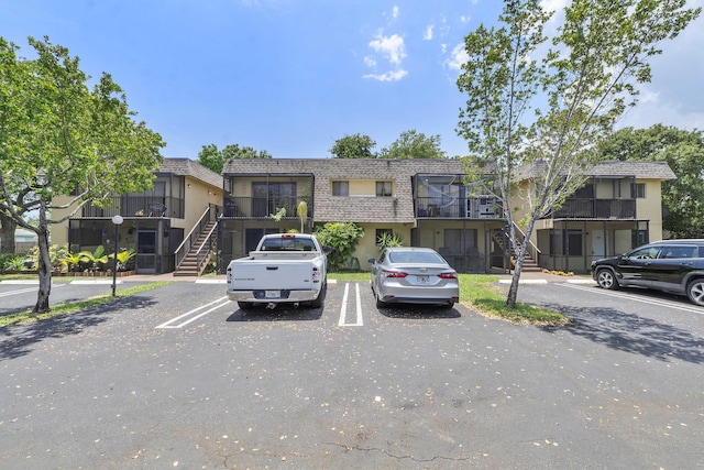 1325 S Flagler Ave Unit 104, Pompano Beach, FL 33060 - view of front of house featuring stairs and uncovered parking