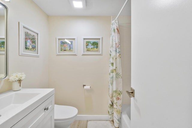 1325 S Flagler Ave Unit 104, Pompano Beach, FL 33060 - full bath featuring toilet, vanity, shower / tub combo, wood finished floors, and baseboards