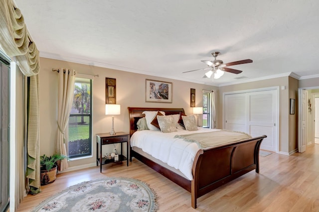 15385 Cedar Bluff Pl, Wellington, FL 33414 - bedroom with light wood-style floors, a closet, ornamental molding, baseboards, and a ceiling fan