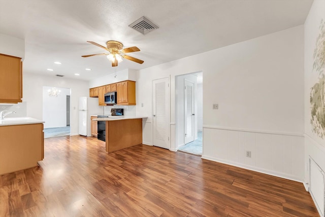 1937 Park Pl, Boca Raton, FL 33486 - kitchen with freestanding refrigerator, stainless steel microwave, electric range, ceiling fan, and wood finished floors