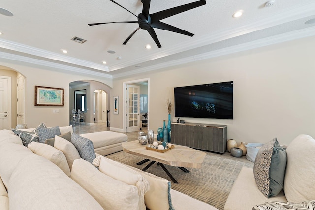 220 Carina Dr, Jupiter, FL 33478 - living room with arched walkways, ornamental molding, ceiling fan, recessed lighting, and a tray ceiling