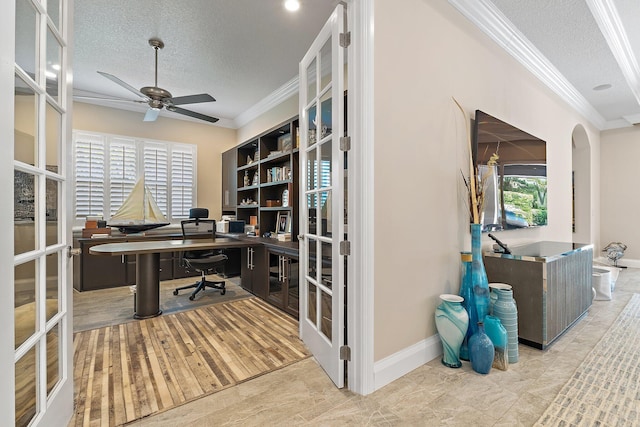 220 Carina Dr, Jupiter, FL 33478 - office area featuring ornamental molding, a textured ceiling, a ceiling fan, arched walkways, and baseboards