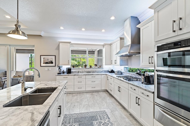 220 Carina Dr, Jupiter, FL 33478 - kitchen with wall chimney exhaust hood, stainless steel appliances, a warming drawer, crown molding, and a sink