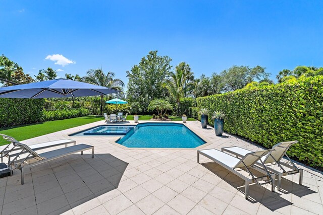 220 Carina Dr, Jupiter, FL 33478 - view of pool featuring a patio, a pool with connected hot tub, and a yard
